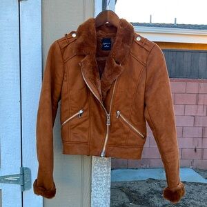 Camel color faux suede jacket. Super cozy, with fur inside.  Never worn.